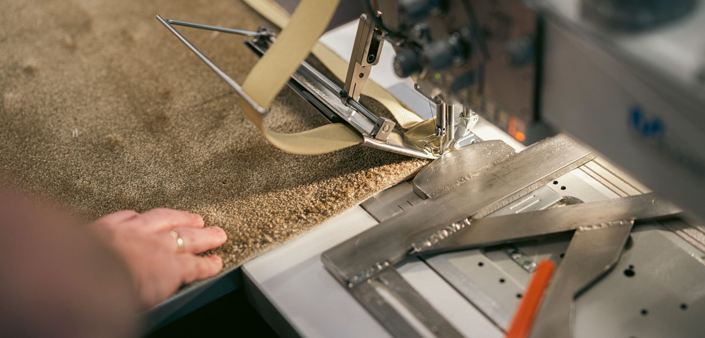 A carpet being finished by hand in the Hillfloor workshop